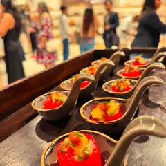 A single bite of freshness. These cherry tomatoes are stuffed with a flavourful filling and served on elegant spoons, making them an easy-to-eat and refreshing appetizer for a standing cocktail event.