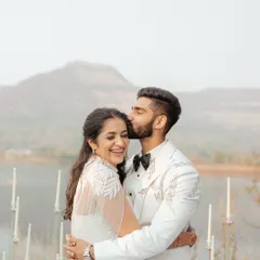 A gentle kiss on the forehead, a moment of pure love and affection against the backdrop of the mountains and lake. This intimate portrait is what timeless wedding photography is all about.