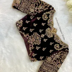 A masterpiece in velvet. This deep wine-colored blouse is covered in royal zardozi embroidery, perfect for a grand reception look.