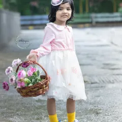A basket of flowers and a sweet smile make for a perfect portrait. I love using simple, natural props that add a touch of charm to my outdoor kids photoshoots without distracting from the child's personality.