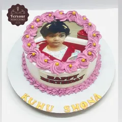 A simple and sweet photo cake for a little girl's birthday. The cake is a classic chocolate truffle flavour, with the photo framed by beautiful piped whipped cream rosettes.
