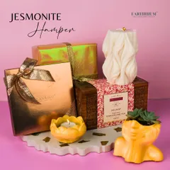 My Jesmonite Hamper is a unique gift, featuring a handmade tray, planter, and tea-light holder, paired with chocolates and tea.