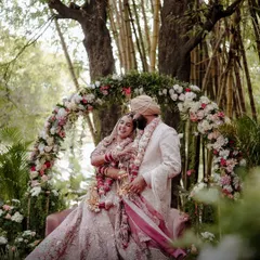 A fairytale moment for a Punjabi couple, framed by a stunning floral arch in a lush Bangalore garden. This shot showcases my approach to creating grand, yet intimate, wedding portraits.