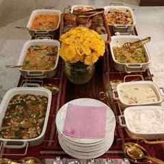 A vibrant and plentiful spread for a Lohri celebration. The menu features a mix of comforting main courses and a basket of assorted breads, perfect for a festive gathering.