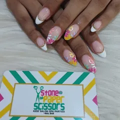 A modern twist on a classic. This is a white-tipped French manicure on almond nails, updated with delicate, hand-painted floral designs for a fresh, spring vibe.