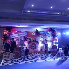 Welcome to Hogwarts! A detailed Harry Potter themed birthday party with a Platform 9 3/4 backdrop, character cutouts, and props like barrels and a Hedwig figure to transport guests to the wizarding world.