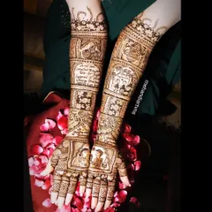 This story mehandi includes panels depicting the couple's journey, their engagement date, and portraits. Every element is carefully drawn to create a beautiful narrative on the arms.