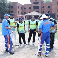 A strategic discussion on the field during the exhibition match. The game was played in a friendly and spirited environment, which is the true win.