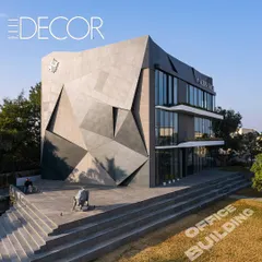 Featured in Elle Decor, this wide view shows how the office building's assertive architecture is integrated with its landscape. The grand steps and the bull statue create a powerful entrance sequence, symbolizing growth and ambition.