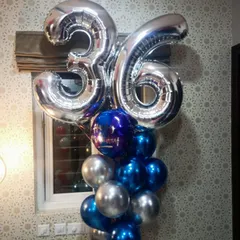 This striking balloon bouquet was designed for a 36th birthday. It features large silver number foils above a base of metallic blue and silver chrome balloons, perfect for a modern and stylish celebration.