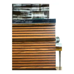 A close-up of a grooved wood detail on a piece of custom furniture. This kind of texture adds depth and a subtle linear pattern that elevates the entire piece.