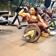 Taking a moment after a tough set. Even when resting, you can see the muscle development that comes from a disciplined lifestyle. This is the physique I help my clients work towards.