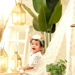 A happy wave from our boho camp. The warm lanterns and natural props create a cozy and inviting scene for her first birthday photos.