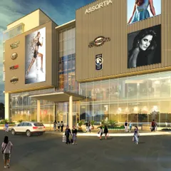 A frontal perspective of the 'Assortia' mixed-use development concept. This view highlights the primary retail facade with its large glass fronts and extensive branding space, designed to create a bustling and attractive shopping environment.