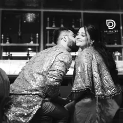 A sweet, stolen kiss during their engagement party. I converted this to black and white to emphasize the emotion and the sparkling details of their celebratory attire.