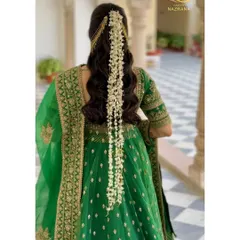 A still shot of the beautiful open hairstyle with a cascading gajra. This look is both traditional and modern, perfect for a bride who wants the best of both worlds.