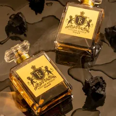 For this luxury perfume, I created a dark and sensual mood by placing the bottles on a reflective, wet surface with pieces of charcoal. This concept was designed to evoke a smoky, intense, and mysterious fragrance.
