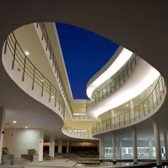 The Pearl Academy in Jaipur showcases our reinterpretation of traditional Indian architecture, like the 'baoli' or stepwell. This central courtyard with its water body acts as a natural coolant and a social hub, creating a dynamic and comfortable environment for students that is both visually dramatic and passively cooled.