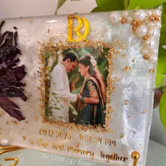 A closer look at the details of this preserved lotus keepsake. The delicate petals, the shimmer of gold flakes, and the couple's special date are all sealed in crystal clear resin to last forever.