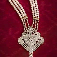 A closer look at an heirloom in the making. This view highlights the intricate setting of diamonds and pearls, where each stone is placed to capture the light. It is crafted for the bride who carries tradition with grace and celebrates her sparkle with confidence.