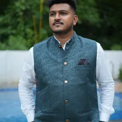 The dark green waistcoat has a subtle traditional pattern, making it a versatile piece for various occasions. Rent it to add a touch of class to your look.