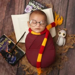 For the parents who dream of a little magic, I offer creative themed shoots. This little wizard, ready for his journey to Hogwarts, shows how we can bring a fun story to life. A Harry Potter themed newborn shoot is a unique way to celebrate your family's passions.