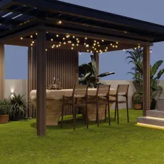 This custom-designed bar under a pergola serves as the social heart of this Gurugram rooftop. The natural stone finish of the bar and warm string lights create an inviting atmosphere for evening entertainment.