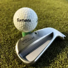 The perfect pairing. A new Titleist T100 iron sits beside our own Hamoni branded Srixon golf ball, ready for a pure strike on the range.