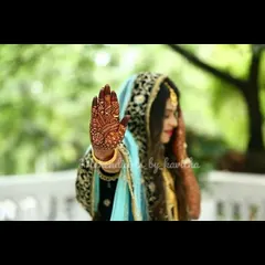 Another shot from a bridal photoshoot, highlighting the deep color of the henna stain. The detailed patterns on the hand and arm look even more beautiful once the color has fully developed.