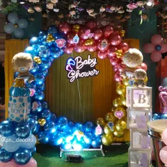 This wide shot shows the complete baby shower decoration setup. The large balloon ring, neon sign, and side elements come together to create a grand and impressive backdrop for your special day.