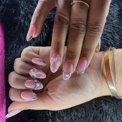 Sheer elegance in this design featuring a natural pink base with delicate, lace-like white and silver details. A sophisticated choice for any bride.