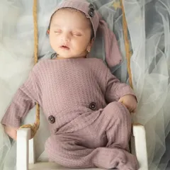 A peaceful little one dreaming on a miniature swing. I use props like this to add a touch of whimsy to my newborn studio sessions.