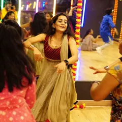 The pure joy of dancing Garba. This candid shot captures one of our students enjoying the festive music and atmosphere of our workshop.