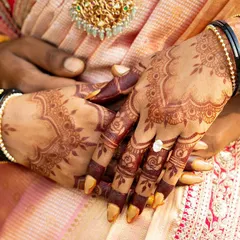 A beautiful close-up of a mature henna stain. The deep color provides a stunning contrast against the bride's skin and her traditional bangles.