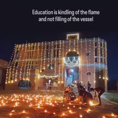 The Ashadeep school in rural Varanasi, lit for a celebration. The accompanying quote, "Education is kindling of the flame and not filling of the vessel," is the guiding principle of my mentoring. I aim to inspire, not just instruct.