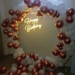 A classic ring balloon arch is perfect for a surprise birthday decoration at home. This one uses a beautiful combination of white and rose gold chrome balloons.