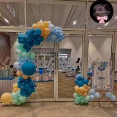 The entrance to our 'One-der the Sea' party, featuring a balloon arch in ocean colors and a personalized welcome sign for the birthday girl, Ayra.