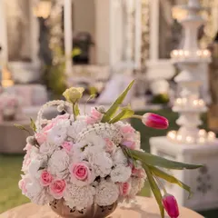 A delicate floral centerpiece with pink roses and white tuberoses in a silver bowl. This arrangement was part of an understated luxury wedding, adding a touch of softness to the tablescape.