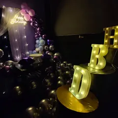 You can add these cool light-up 'HBD' letters to any decoration package. They look great in photos and add a personalized touch to the birthday setup, especially in the dimmed theatre lighting.