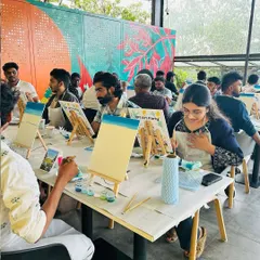 A room buzzing with creative energy! I guide everyone step-by-step, so even total beginners feel confident and can enjoy the process of painting.