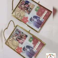 A pair of custom vintage-style hanging glass frames. These frames have a classic, elegant look and are perfect for displaying cherished photos.