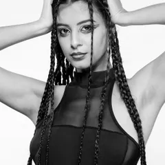 A high-contrast monochrome portrait featuring intricate braids and graphic eyeliner. This shot showcases my ability to create edgy, conceptual looks in the studio.