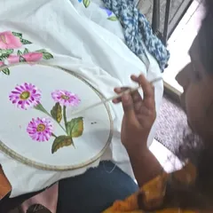 We love seeing our students get lost in the creative process. This is a quiet moment from a fabric painting session, focusing on adding delicate details to a floral design. No experience is needed, just a willingness to try.