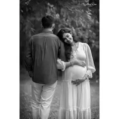 A classic couple pose rendered in beautiful black and white. The lack of color emphasizes the emotional connection as she rests her head on his shoulder.