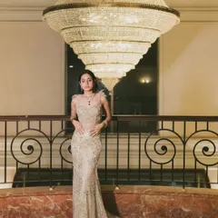 A solo portrait of the bride-to-be, Anmol, standing beneath a stunning tiered chandelier. I wanted to create an image that highlighted her grace and the exquisite detail of her gown in a grand, architectural setting.
