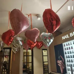 A closer look at the Valentine's Day decor near the salon's nail bar. I used a mix of red, pink, and silver foil balloons to create a romantic and chic color palette that complemented the store's existing interior.