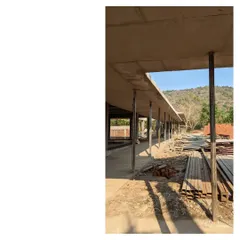 The raw concrete frame of the Alibaug family commune, with the hillscape visible in the background. The space between the structures is what the project is about, creating an atmosphere of country life.