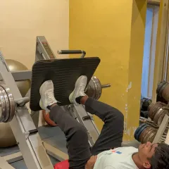 The leg press machine is a core piece of equipment for building lower body strength. Here, a member focuses on his form during a set. We have a wide variety of machines to target every major muscle group effectively.