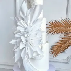 Imagine creating wedding cakes this elegant and flawless. This three-tiered white architectural cake showcases the modern wafer paper techniques and sharp edges you'll master in our advanced workshops.