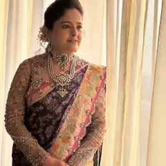 An exceptionally elegant look for a wedding guest. The makeup is subtle and refined, with a focus on flawless skin to complement her intricate designer saree and statement pearl jewelry.